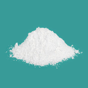 A pile of loose powder chalk sitting upon a turquoise background. 